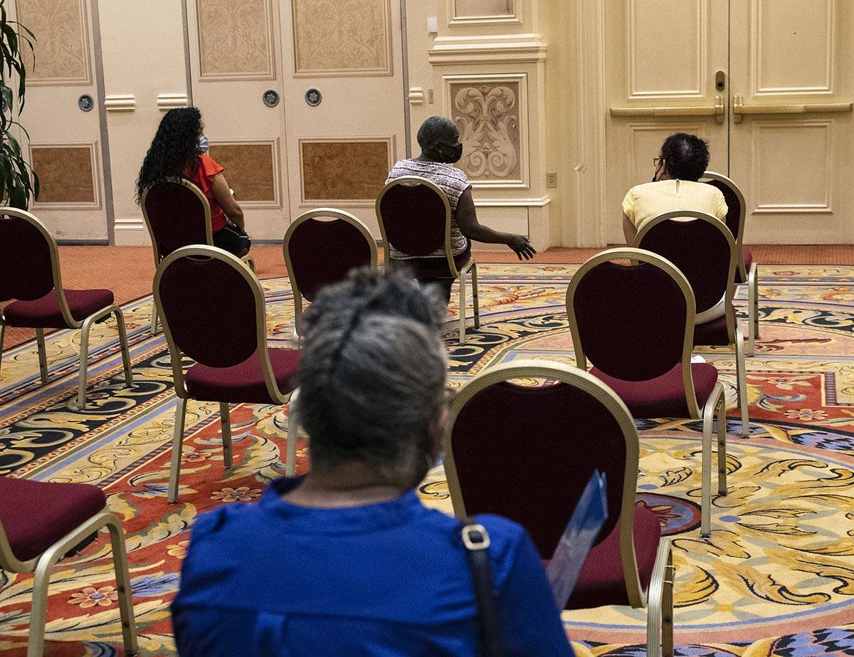 Jobs seekers wait after filling out their jobs applications during the Venetian hotel-casino ca ...