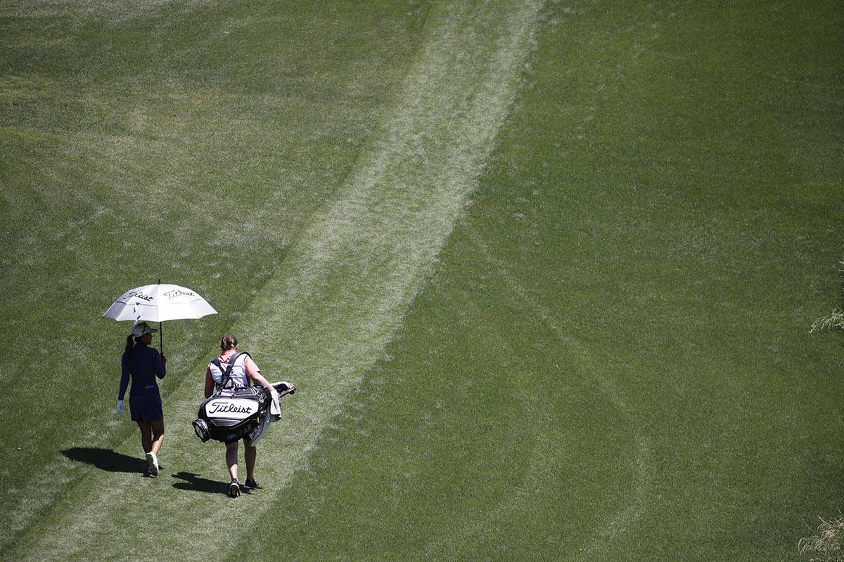 Danielle Kang of USA walks with her caddie after teeing off on the second hole during the third ...
