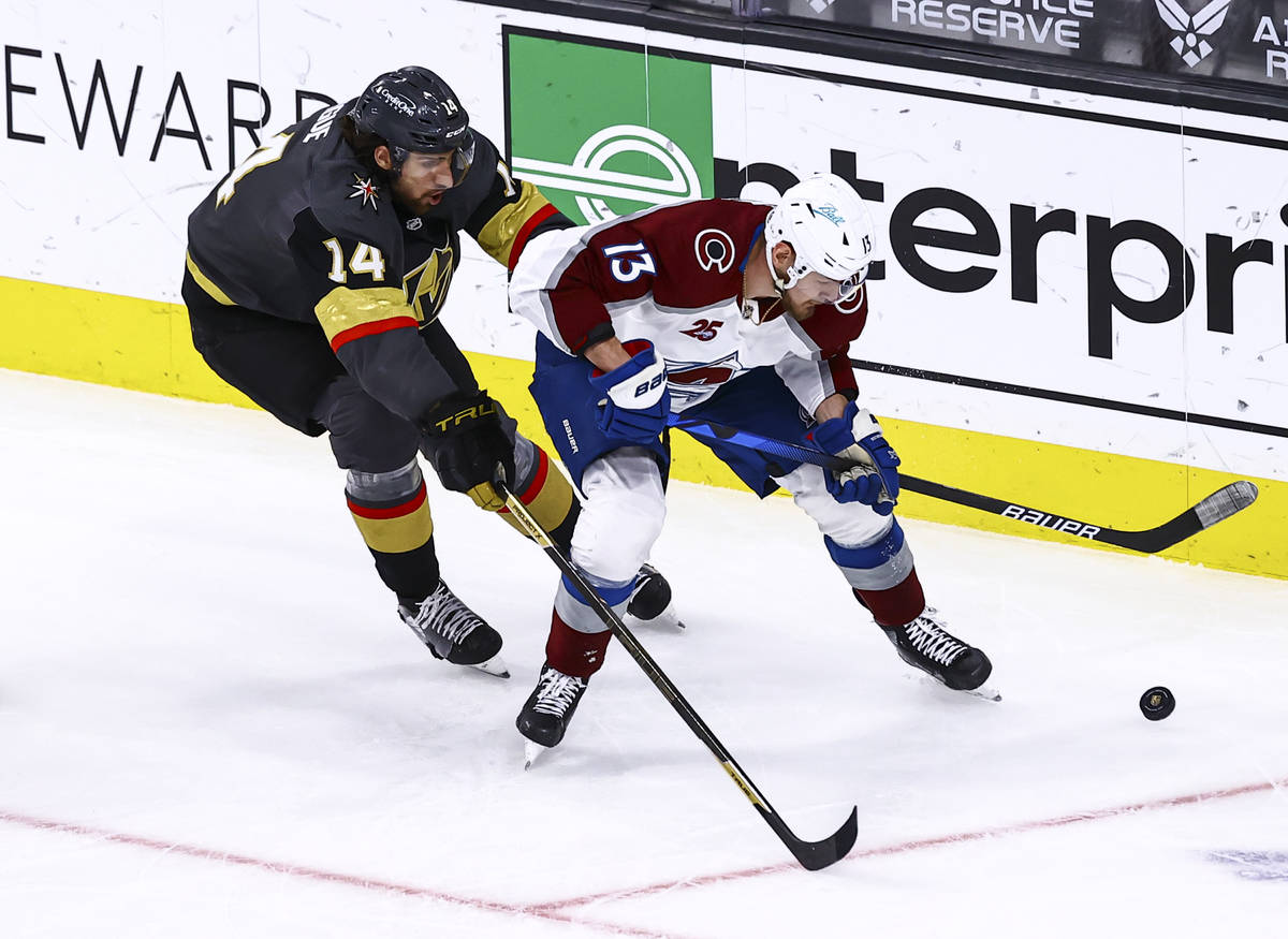 Colorado Avalanche's Valeri Nichushkin (13) skates with the puck under pressure from Golden Kni ...