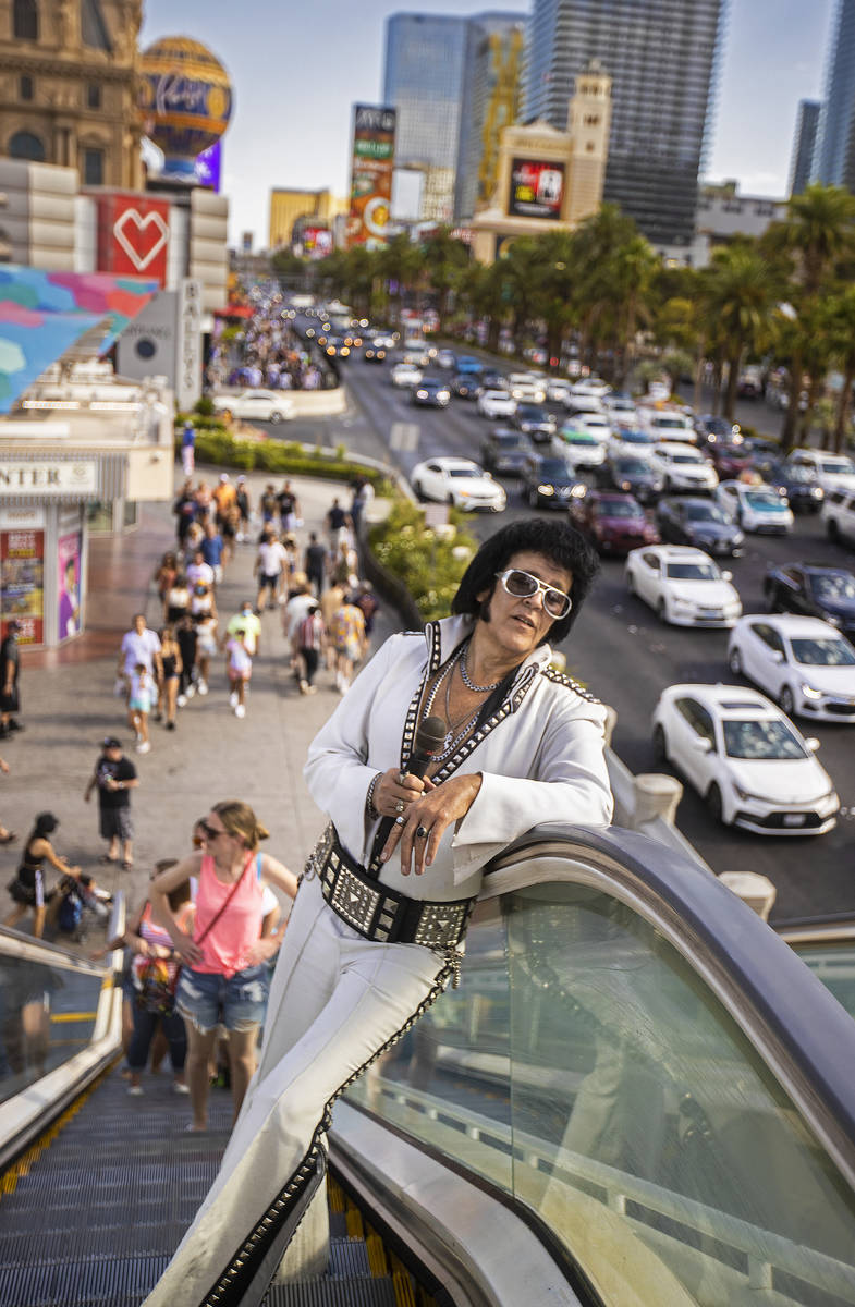 Chris Johnson, known as ÒCounterfeit Elvis,Ó makes his way up the escalator on The St ...