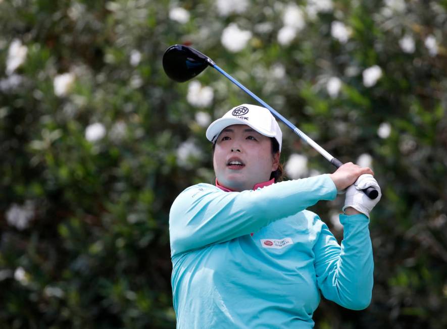 Shanshan Feng watches her tee shot on the first hole during the quarter final round of the Bank ...