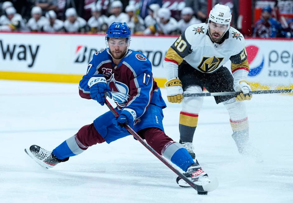 Colorado Avalanche center Tyson Jost (17) grabs the puck against Vegas Golden Knights center Ch ...