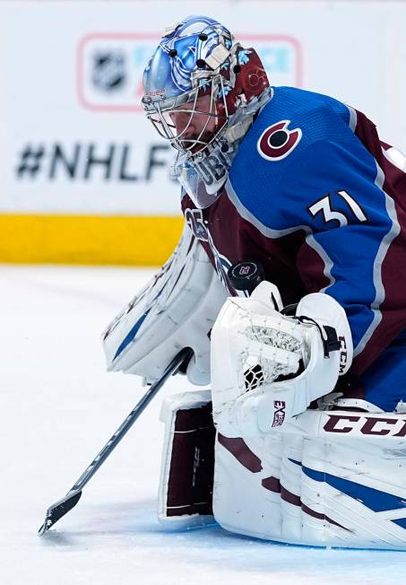 Colorado Avalanche goaltender Philipp Grubauer (31) blocks a shot by the Vegas Golden Knights i ...