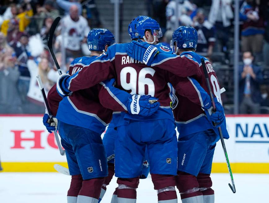 Colorado Avalanche left wing Gabriel Landeskog (92) is congratulated by teammates Cale Makar (8 ...