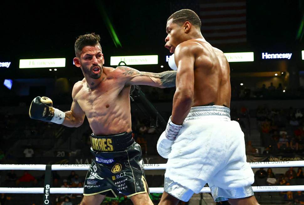 Jorge Linares, left, hits Devin Haney during a WBC lightweight title boxing match Saturday, May ...