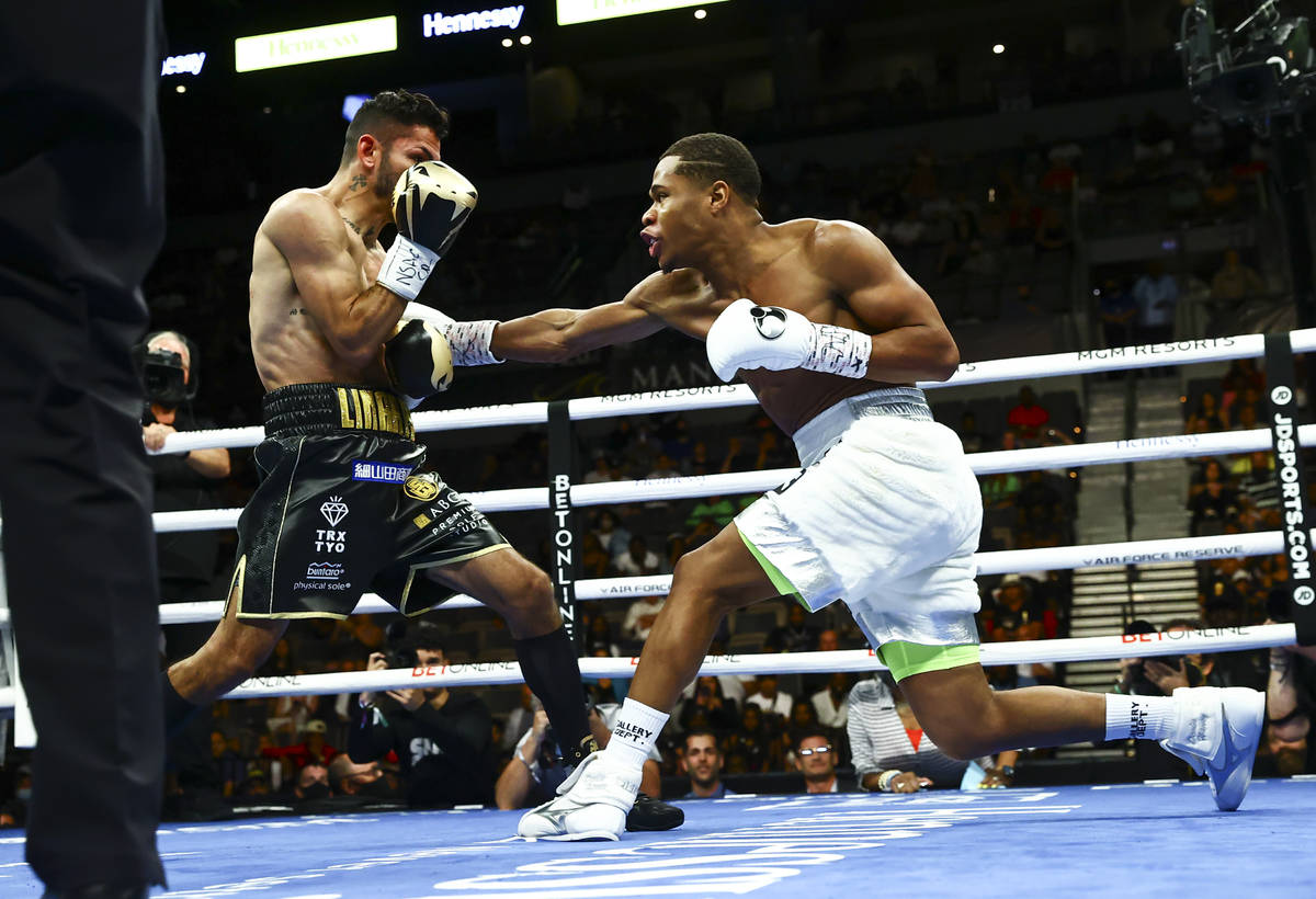 Jorge Linares, left, takes a hit from Devin Haney during the WBC lightweight title boxing match ...