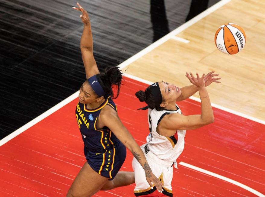 Las Vegas Aces guard Chelsea Gray (12) attempts to block the shot of Indiana Fever guard Tiffan ...