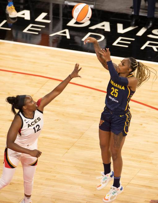 Las Vegas Aces center Liz Cambage (8) drives past Indiana Fever forward Jantel Lavender (14) in ...