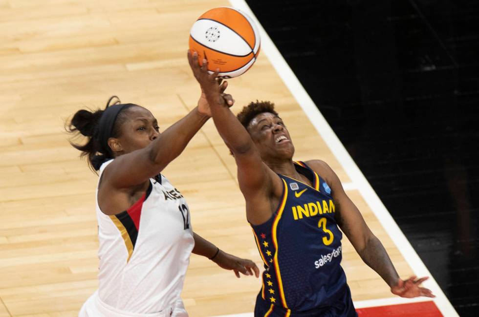 Indiana Fever guard Victoria Vivians (35) and Indiana Fever forward Teaira McCowan (15) fight f ...