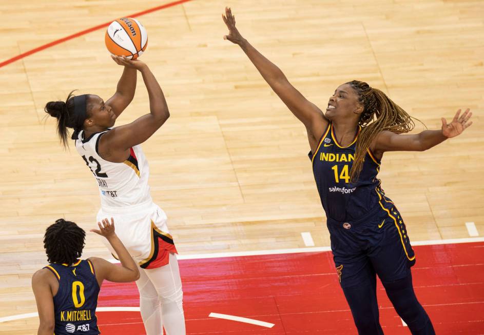 Las Vegas Aces guard Chelsea Gray (12) shoots over Indiana Fever forward Jantel Lavender (14) a ...