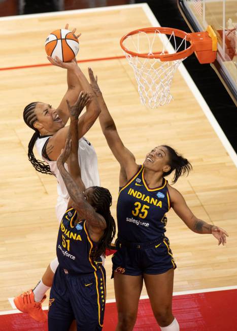 Las Vegas Aces center Liz Cambage (8) shoots over Indiana Fever forward Jessica Breland (51) an ...