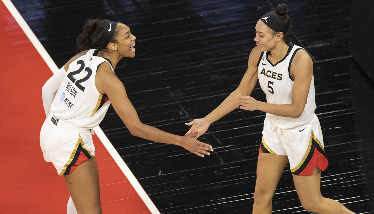 Las Vegas Aces forward A'ja Wilson (22) celebrates a big play with Las Vegas Aces forward Deari ...