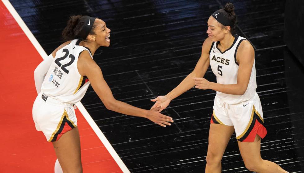 Las Vegas Aces forward A'ja Wilson (22) celebrates a big play with Las Vegas Aces forward Deari ...