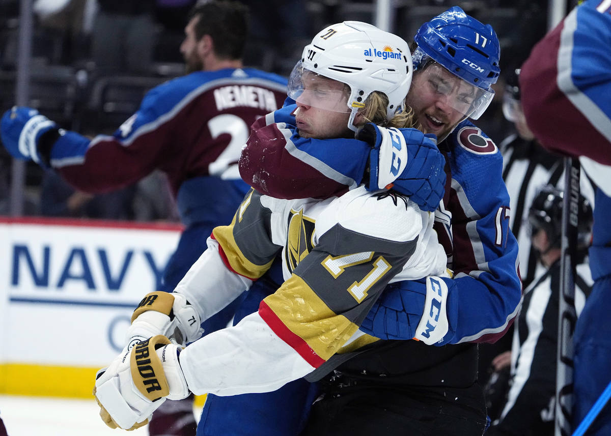 Colorado Avalanche center Tyson Jost (17) fights with Vegas Golden Knights center William Karls ...