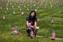 Alysa Arias lays flowers at the grave site of an Air Force veteran she considered Ҭike fa ...