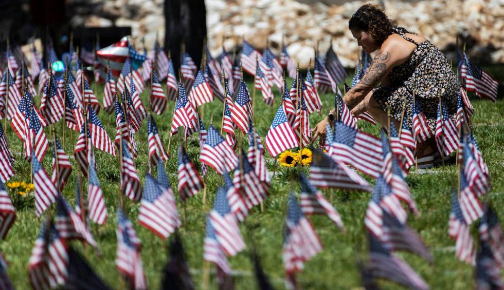 Attendees of a Memorial Day ceremony visit the grave sites of deceased veterans on Monday, May ...