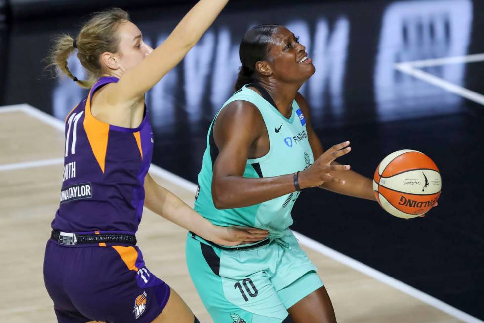 New York Liberty's Joyner Holmes (10) drives past Phoenix Mercury's Alanna Smith during the fir ...