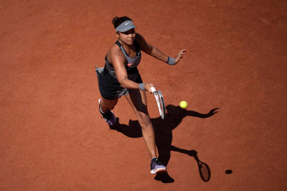 Japan's Naomi Osaka returns the ball to Romania's Patricia Maria Tig during their first round m ...