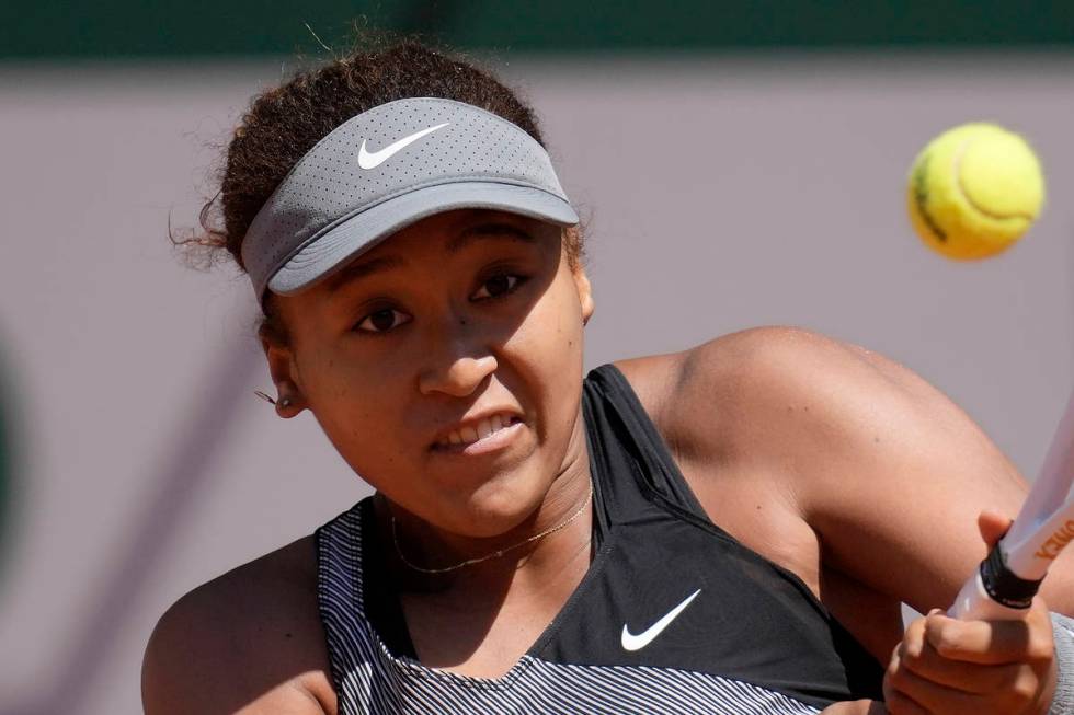 FILE - Japan's Naomi Osaka returns the ball to Romania's Patricia Maria Tig during their first ...