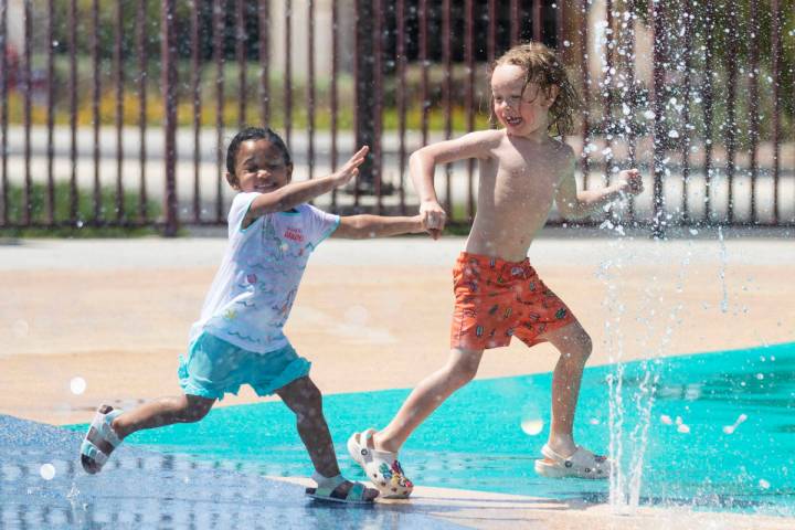 Heavynn Bradford, 2, left, plays with Zane Peters, 4, at Paseo Vista Park, on Wednesday, June 2 ...