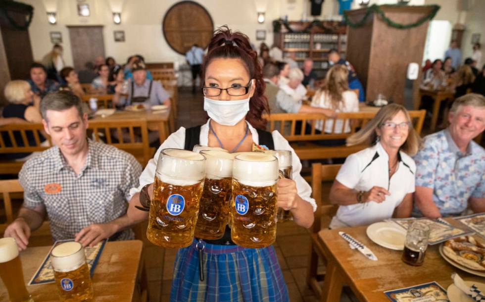 Waitress Jennifer Alcantara delivers beer to a table during the grand reopening of Hofbrauhaus ...