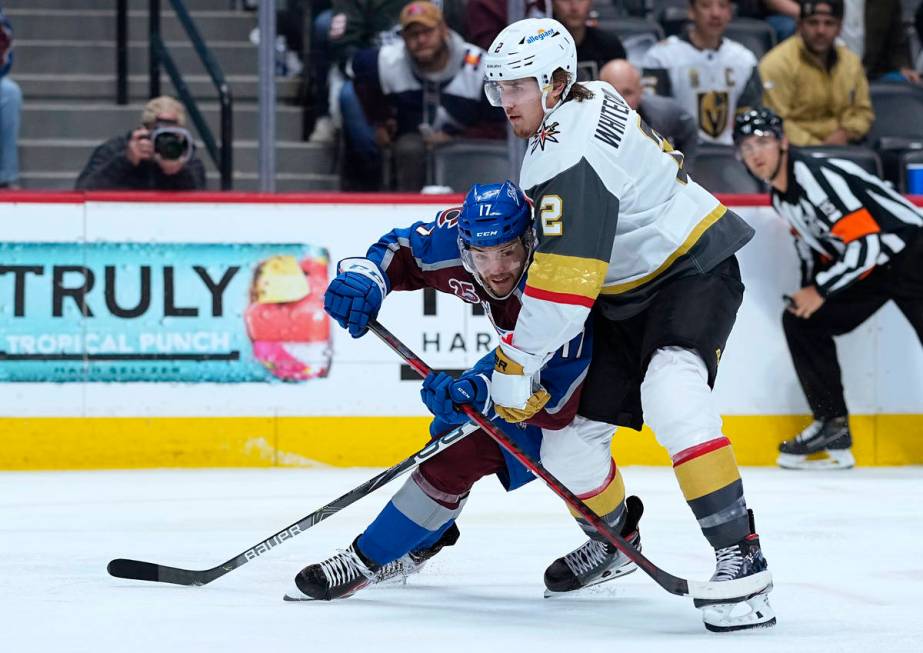 Vegas Golden Knights defenseman Zach Whitecloud (2) holds Colorado Avalanche center Tyson Jost ...