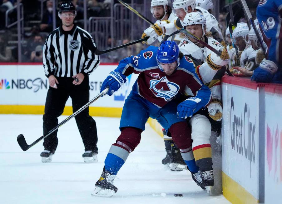 Colorado Avalanche left wing Brandon Saad (20) checks Vegas Golden Knights center William Karls ...