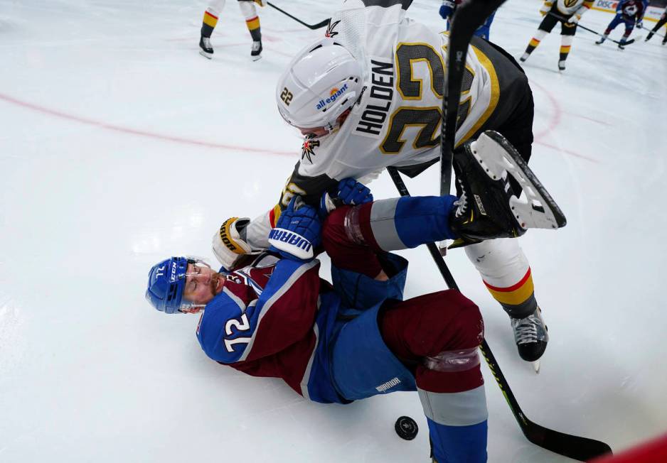 Vegas Golden Knights defenseman Nick Holden (22) knocks Colorado Avalanche right wing Joonas Do ...