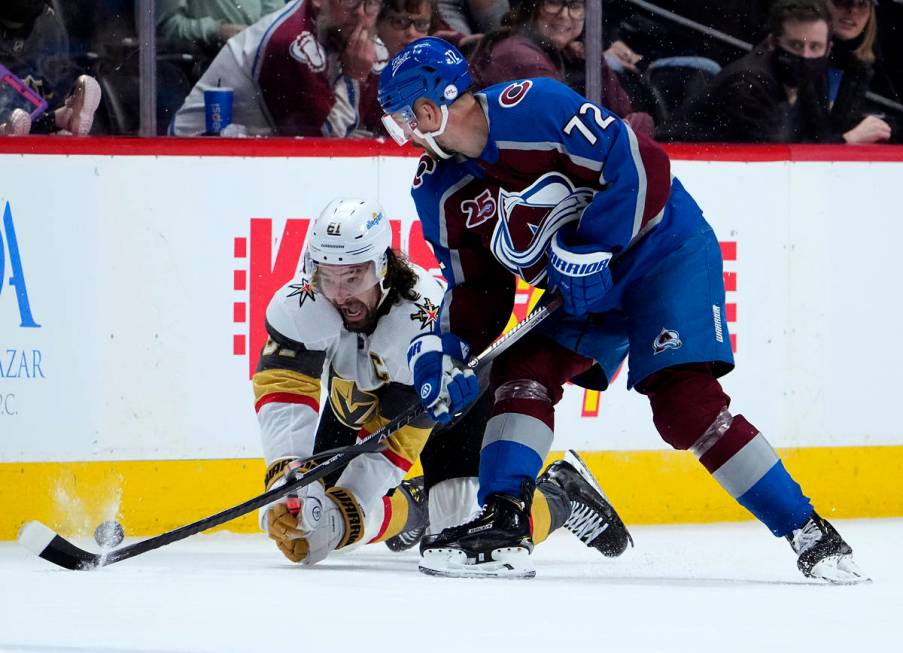 Vegas Golden Knights right wing Mark Stone (61) dives to get the puck from Colorado Avalanche r ...