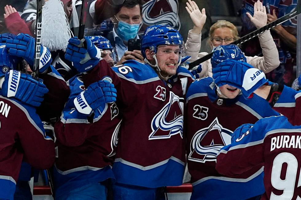 Colorado Avalanche right wing Mikko Rantanen, center, is congratulated by teammates after scori ...