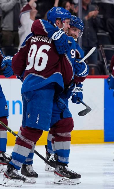 Colorado Avalanche right wing Mikko Rantanen (96) is congratulated by Devon Toews (7) after sco ...