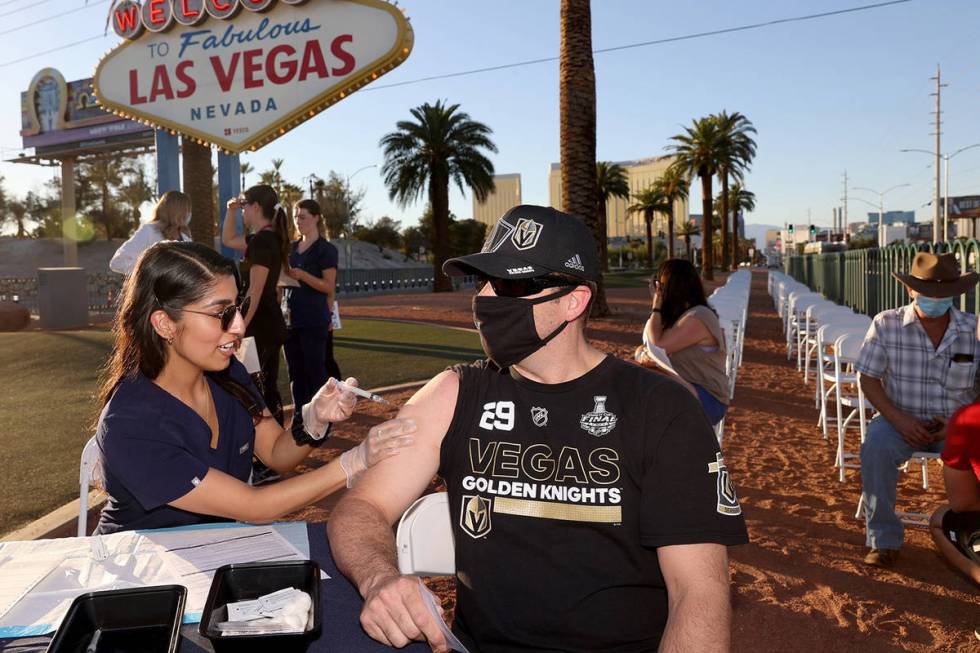 Touro University Physician Assistant student Aanchal Shahani gives Josh Cyriacks of Henderson a ...