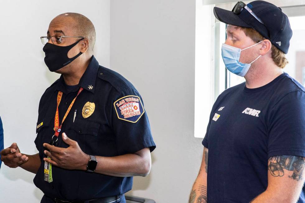 Jon Stevenson II, assistant fire chief at Las Vegas Fire and Rescue, left, speaks during a tour ...