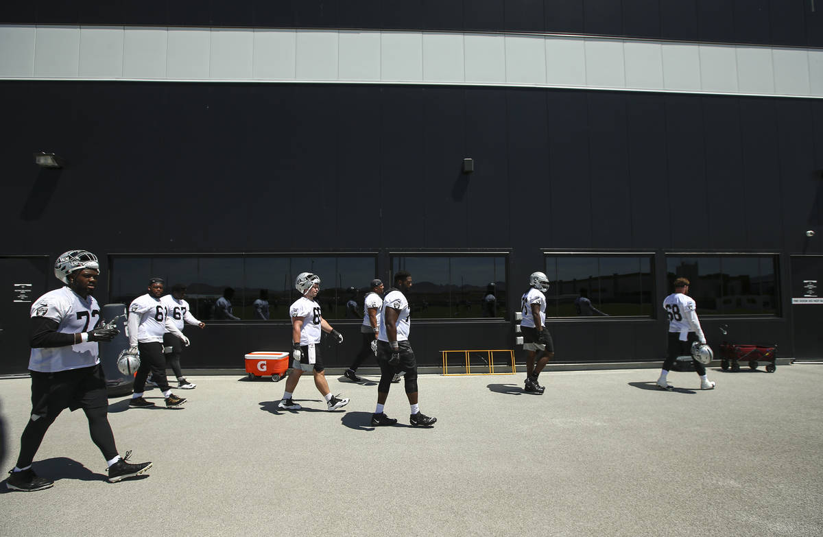 Raiders walk off the field during NFL football practice at Raiders headquarters in Henderson on ...
