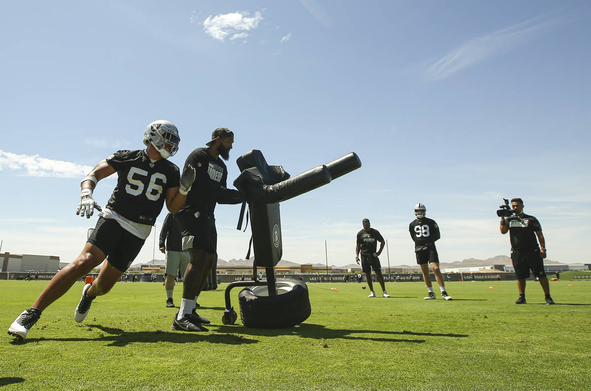Raiders defensive end Matt Dickerson (56) runs through drills during NFL football practice at R ...