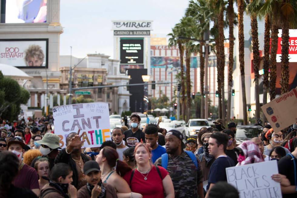 Supporters and members of the Black Lives Matter movement march down a closed-off Las Vegas Bou ...