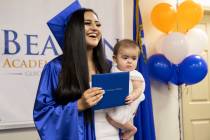 Jennifer Amaya holds her diploma with Violet Montanez, 7 months, during graduation for Beacon A ...