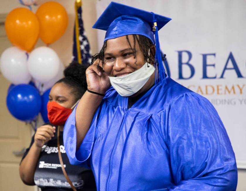 Jordan Green, right, shares a laugh with Beacon Academy of Nevada staff during graduation on We ...