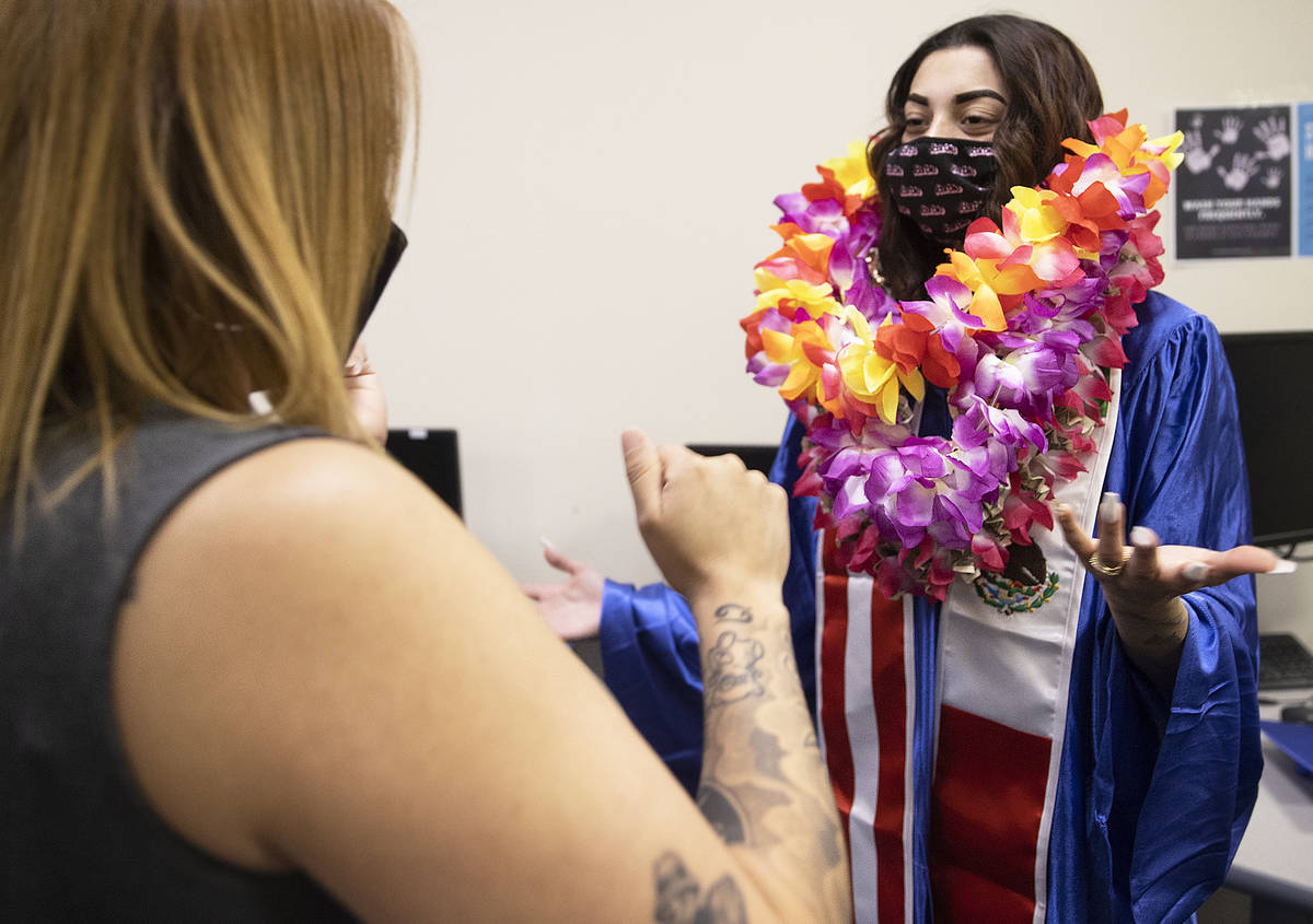 Savannah Valle, right, is overwhelmed by Hawaiian leis during graduation for Beacon Academy of ...