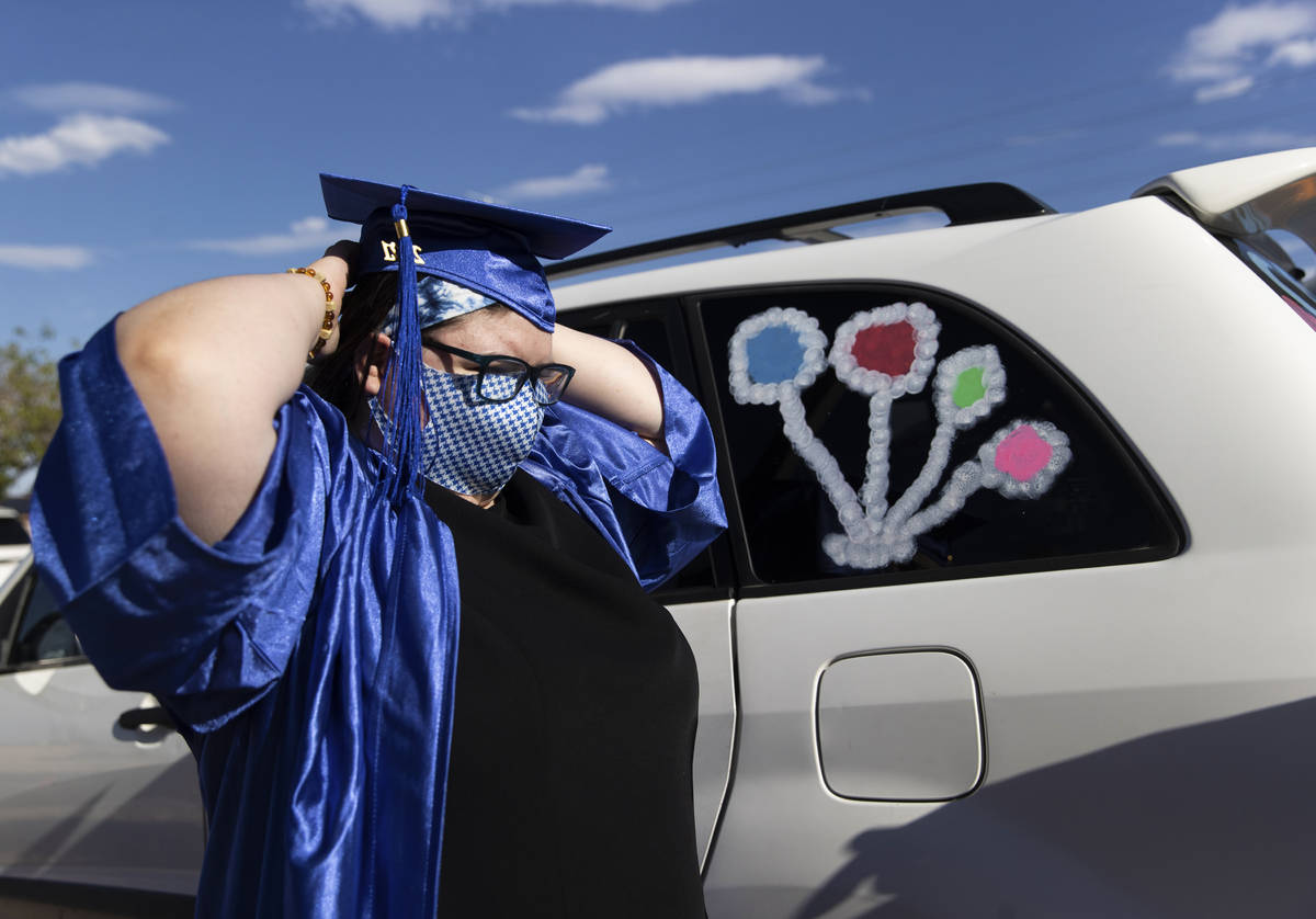 Jezaqua Norman straightens her cap before graduation for Beacon Academy of Nevada on Wednesday, ...