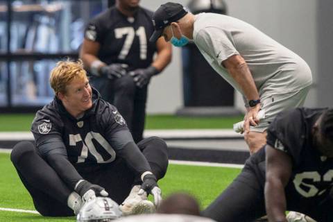 Las Vegas Raiders offensive tackle Sam Young (70) listens to defensive line coach Rod Marinelli ...
