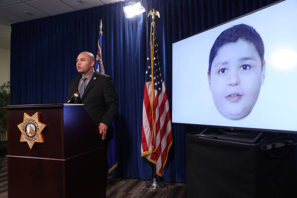 Las Vegas police homicide Lt. Ray Spencer shows a a digitally enhanced photograph of a young bo ...