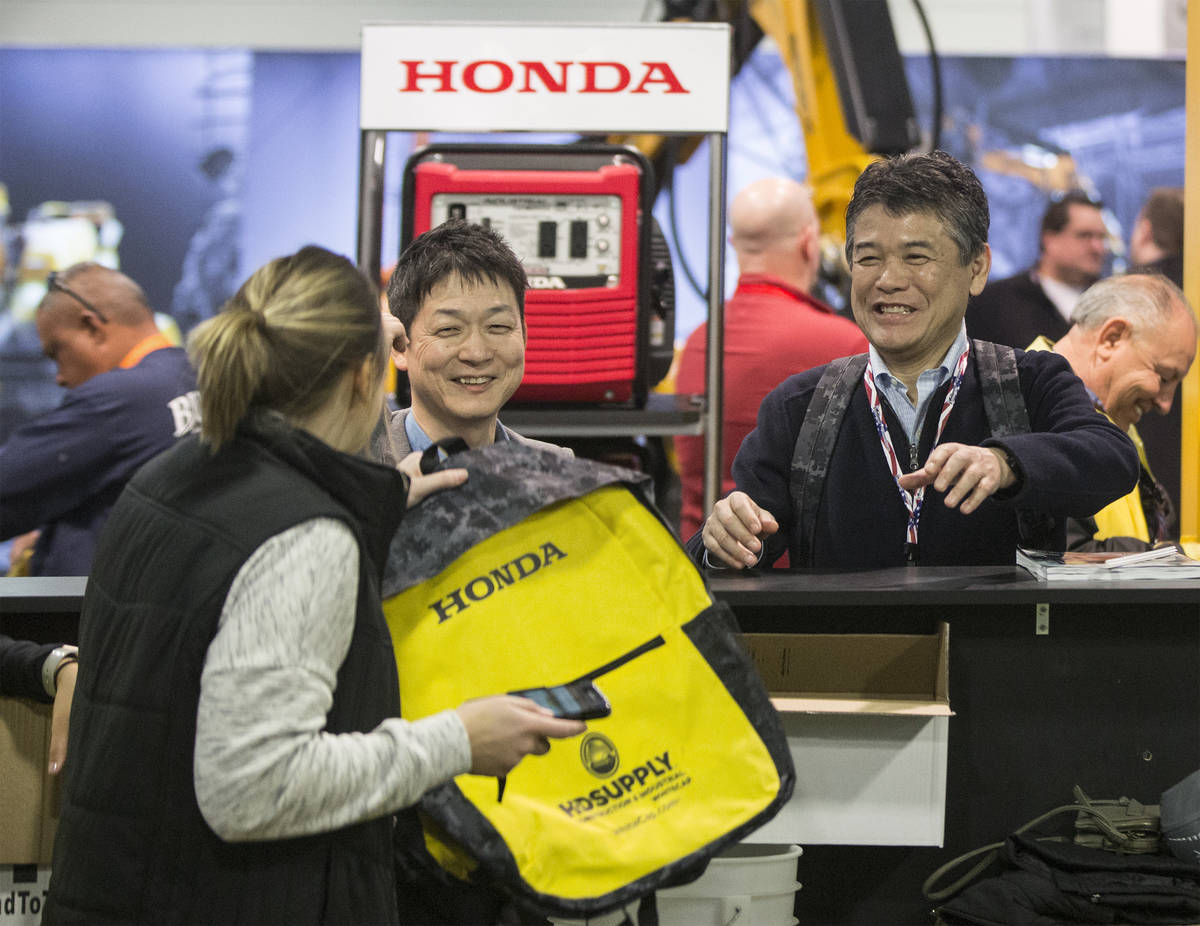 Tom Akahane, right, with Fister, picks up a complimentary HD Supply backpack during the last da ...