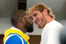 Floyd Mayweather, left, and and Logan Paul, right, face off during a press event, Thursday, Jun ...
