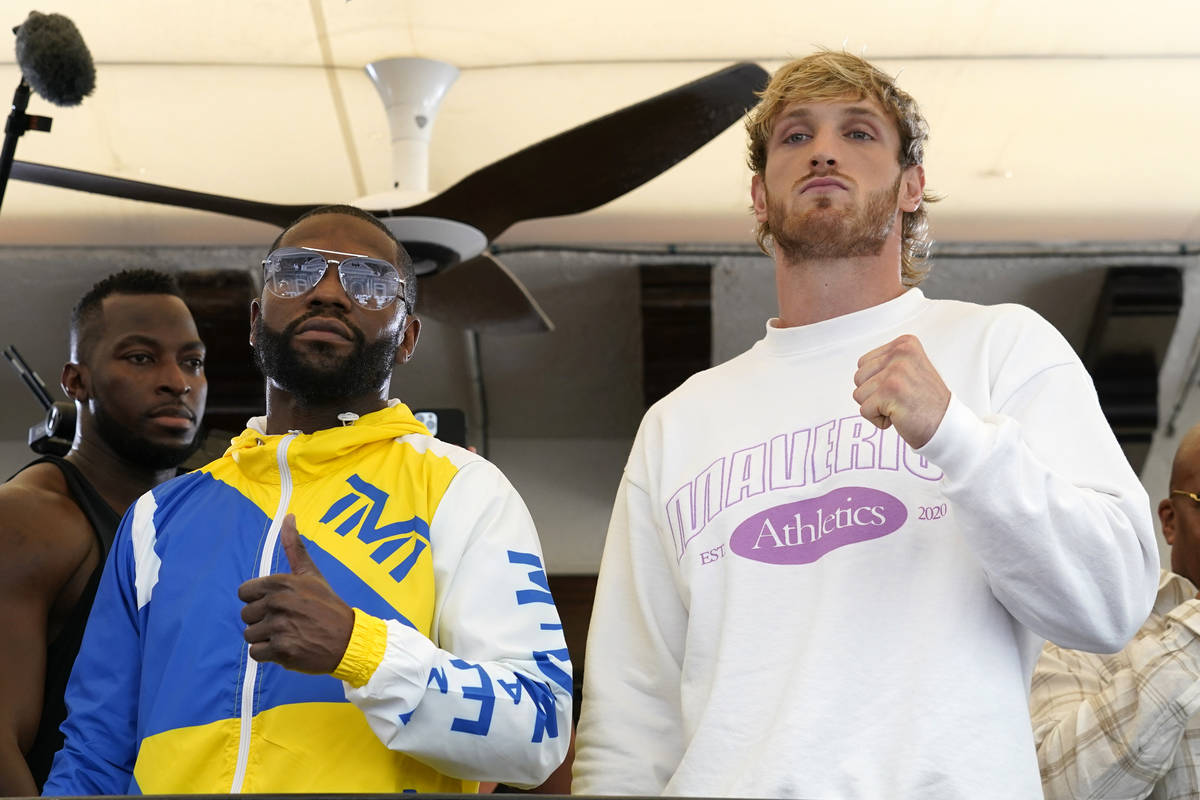 Floyd Mayweather, left, and Logan Paul, right, pose for a photograph during a press event, Thur ...