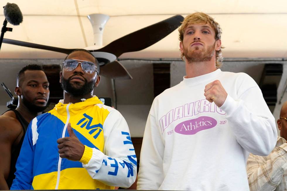 Floyd Mayweather, left, and Logan Paul, right, pose for a photograph during a press event, Thur ...