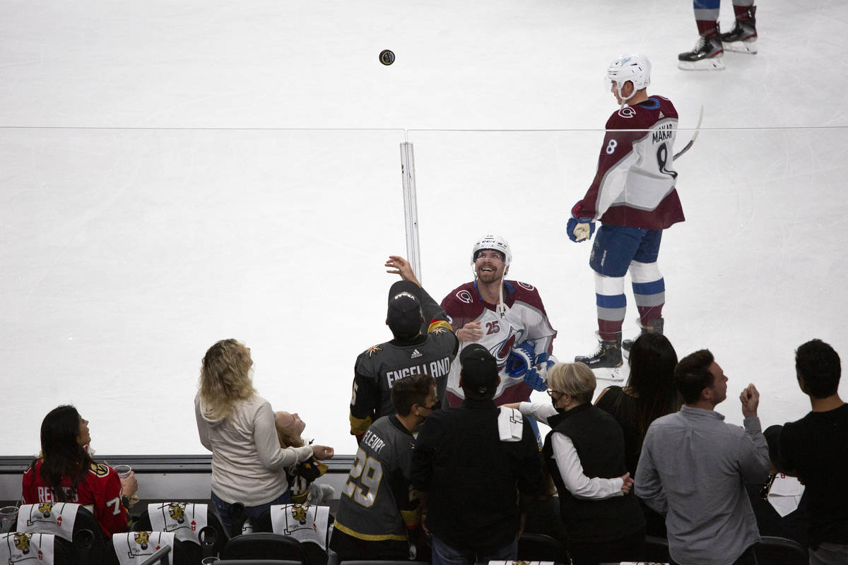 Avalanche center Jayson Megna (12) tosses a puck to fans before Game 3 of a second-round NHL ho ...