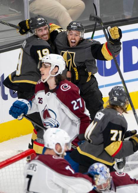 Golden Knights right wing Reilly Smith (19) embraces Golden Knights center Jonathan Marchessaul ...