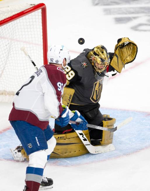 Golden Knights goaltender Marc-Andre Fleury (29) makes a save next to Avalanche left wing Gabri ...