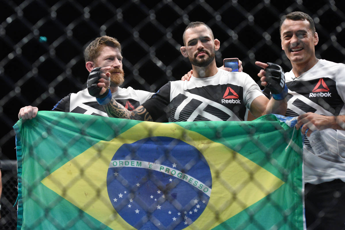 Santiago Ponzinibbio (blue gloves) poses with his corner crew after defeating Gunnar Nelson (no ...